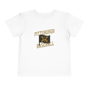 Ahoy, mini mateys! Set sail for adventure with our Toddler Pittsburgh Pirates Shirt!