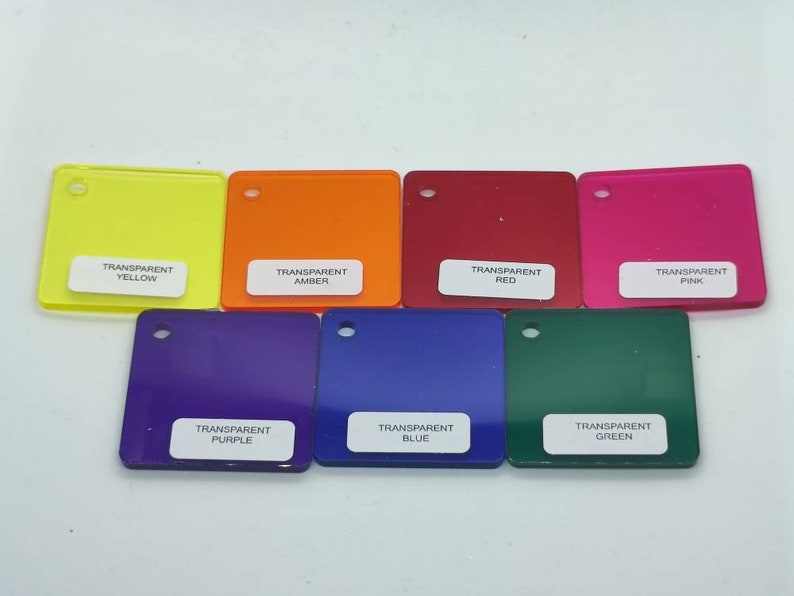 May include: Eight square pieces of transparent acrylic in different colors: yellow, orange, red, pink, purple, blue, green, and clear. Each piece has a white label with the color name printed on it.