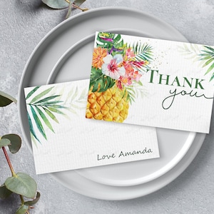 May include: Two thank you cards with a tropical theme. The top card features a pineapple with green leaves and pink flowers. The bottom card has a green leaf design and the text "Love Amanda".