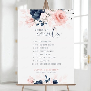 May include: A wedding sign featuring a floral design in shades of pink and blue. The sign lists the order of events for the wedding, including the ceremony, social hour, dinner, first dance, speeches, cake cutting, dancing, and sparkler send off. The sign also includes the names Olivia and Matthew, the date 05.19.20XX, and the location Chicago.