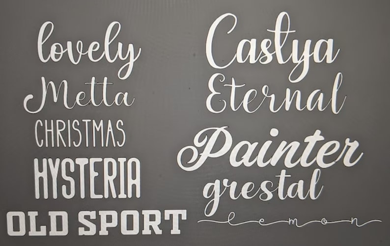May include: A gray background with white text. The text reads "lovely", "Metta", "Christmas", "Hysteria", "Old Sport", "Castlya", "Eternal", "Painter", "grestal", and "lemon".