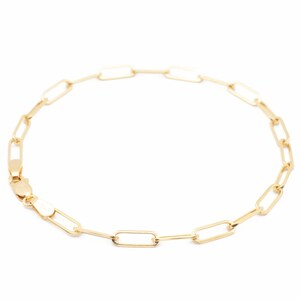 May include: A gold chain bracelet with a simple, linked design. The bracelet is made of small, rectangular links.