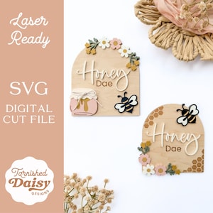 May include: Wooden signs with a honeybee theme. The signs feature the words "Honey Dae" in cursive, along with a honey jar and a bee. The signs are decorated with flowers and honeycomb patterns. The text "Laser Ready", "SVG", and "Digital Cut File" are also visible.