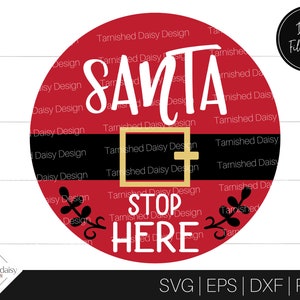 May include: Red circle with the words "Santa Stop Here" in white and black lettering. The circle has a black belt with a gold buckle and the word "Tarnished Daisy Design" repeated around the edge.