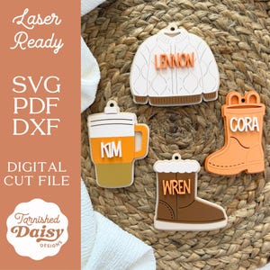 May include: A collection of laser-cut wooden ornaments in the shape of a sweater, coffee mug, rain boot, and winter boot. Each ornament has a name on it: Lennon, Kim, Cora, and Wren. The image also includes the text "Laser Ready", "SVG PDF DXF", and "Digital Cut File".
