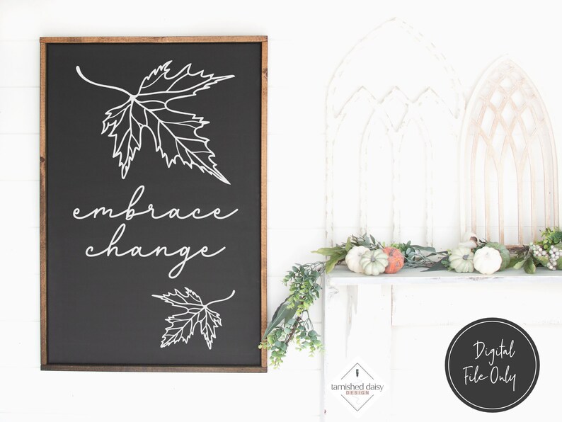 May include: Black and white digital download of a sign with the text "embrace change" and a stylised maple leaf design. The sign is framed in a dark wood frame.