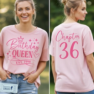 May include: A pale pink t-shirt featuring the text "Birthday Queen" and "Est. 1990" in pink. The back of the shirt displays "Chapter 36" in pink. The shirt is paired with blue denim jeans.