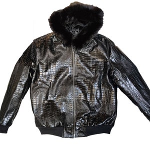 May include: A black leather bomber jacket with a faux fur hood. The jacket has a crocodile-embossed pattern.