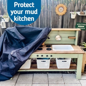 May include: A wooden mud kitchen with a black cover, white sink, and stove top. The kitchen has a light green frame, white storage baskets, and the text "Protect your mud kitchen".