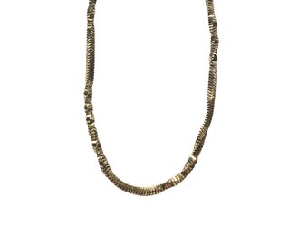 May include: A gold chain necklace with a snake chain design.