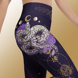 May include: Purple leggings with a gold and white snake design, moon phases, and celestial details.