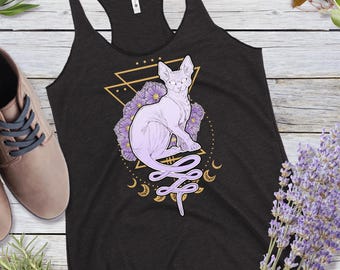 May include: A black tank top with a graphic of a white hairless cat with purple flowers and a gold geometric design. The cat is sitting with its tail curled around its body.