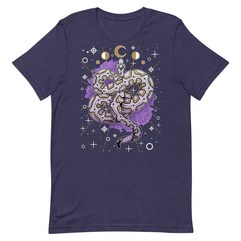 May include: A navy blue t-shirt featuring a white and gold design of a snake with purple flowers and celestial symbols.