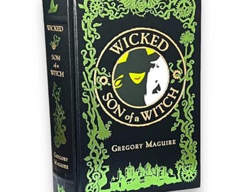 May include: A black hardcover book with a green and gold design. The title is "Wicked: Son of a Witch" by Gregory Maguire.