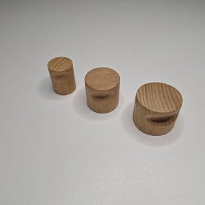 Peut inclure: Trois boutons en bois de différentes tailles. Les boutons sont tous ronds et ont une finition lisse et naturelle.