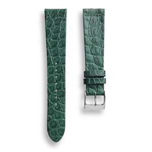 May include: A green leather watch strap with a crocodile pattern.