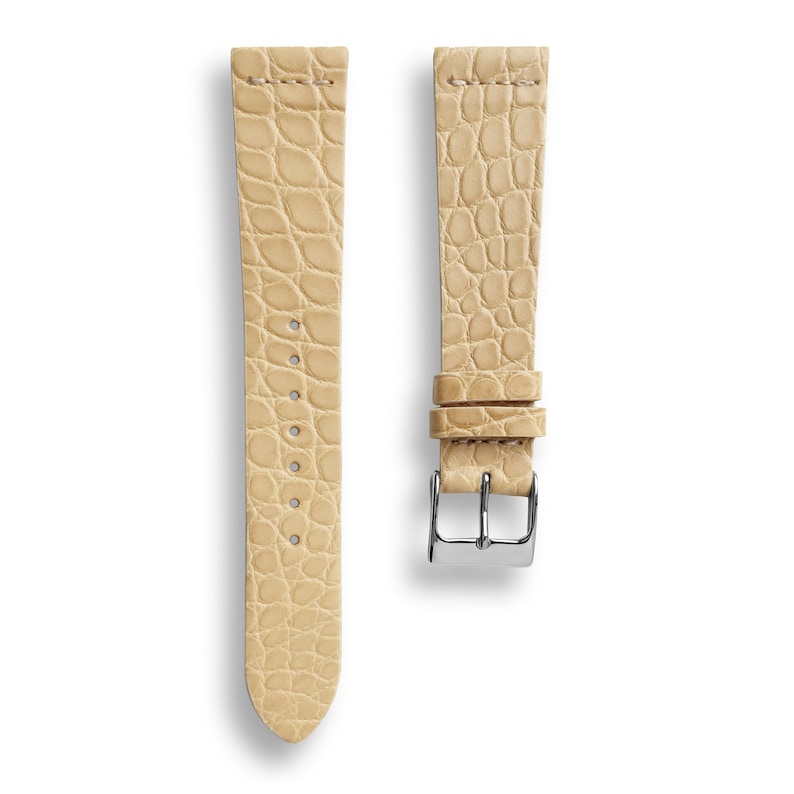 May include: A light beige alligator leather watch strap with a silver buckle.