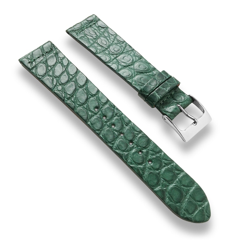 May include: A green alligator leather watch strap with a silver buckle.