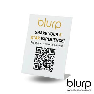 May include: White sign with a black and white QR code, the text "blurp" in gold, and the text "SHARE YOUR 5 STAR EXPERIENCE! Tap or scan to leave us a review!" in black. The sign is on a white stand with the text "blurp" in gold and the text "www.blurpdevices.com" in black.
