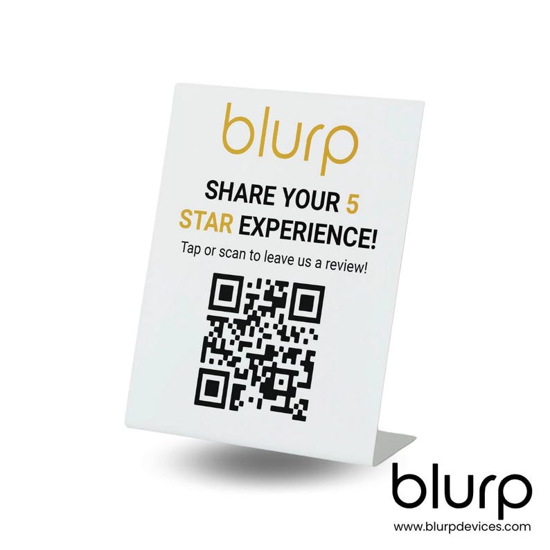 May include: White sign with a black and white QR code, the text "blurp" in gold, and the text "SHARE YOUR 5 STAR EXPERIENCE! Tap or scan to leave us a review!" in black. The sign is on a white stand with the text "blurp" in gold and the text "www.blurpdevices.com" in black.