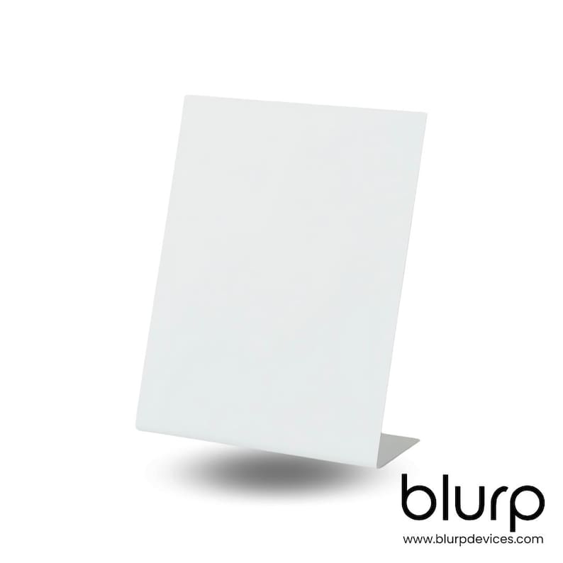May include: White acrylic display stand with a rectangular base and a slanted surface. The stand is designed to hold small items, such as jewelry or other small objects.