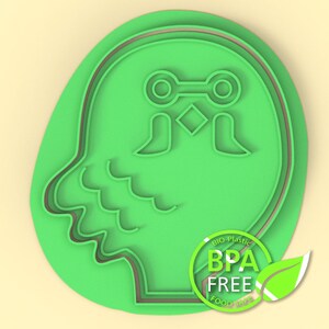 K&ouml;nnte beinhalten: Gr&uuml;ner Plastik-Ausstecher in Form eines Eulenkopfes mit gro&szlig;en Augen und einem Schnabel. Der Ausstecher hat eine doppelte Umrandung und die Worte "BPA FREE" sind auf einem gr&uuml;nen Kreis mit einem Blatt aufgedruckt.