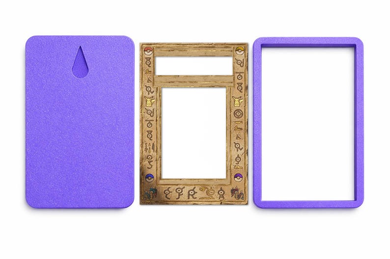 May include: A three-part set comprising a purple backing with a keyhole, a wooden frame with etched symbols and a white centre, and a purple frame. The wooden frame has a rectangular opening.