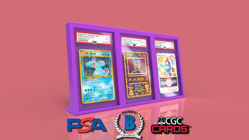 May include: Three Pokemon trading cards are displayed in a purple acrylic case. The cards are encased in protective plastic sleeves. The cards are from the Japanese set, "2000 P.M. Japanese Gold Star Final Battle Holo Promo/Battle." The cards feature the Pokemon, "Blastoise", "Mewtwo", and "Charizard".