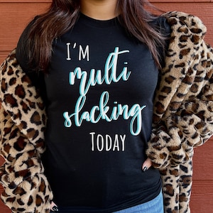 May include: A black t-shirt with the text "I'm multi-tasking today" in blue lettering.