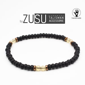 Armband citrien: matzwarte kralen, minimalistische stijl