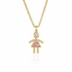 May include: A gold-toned necklace featuring a pendant shaped like a stylized figure. The head is a round clear stone, while the triangular body is a faceted pink stone. The arms and legs are made of small gold beads on a delicate box chain.