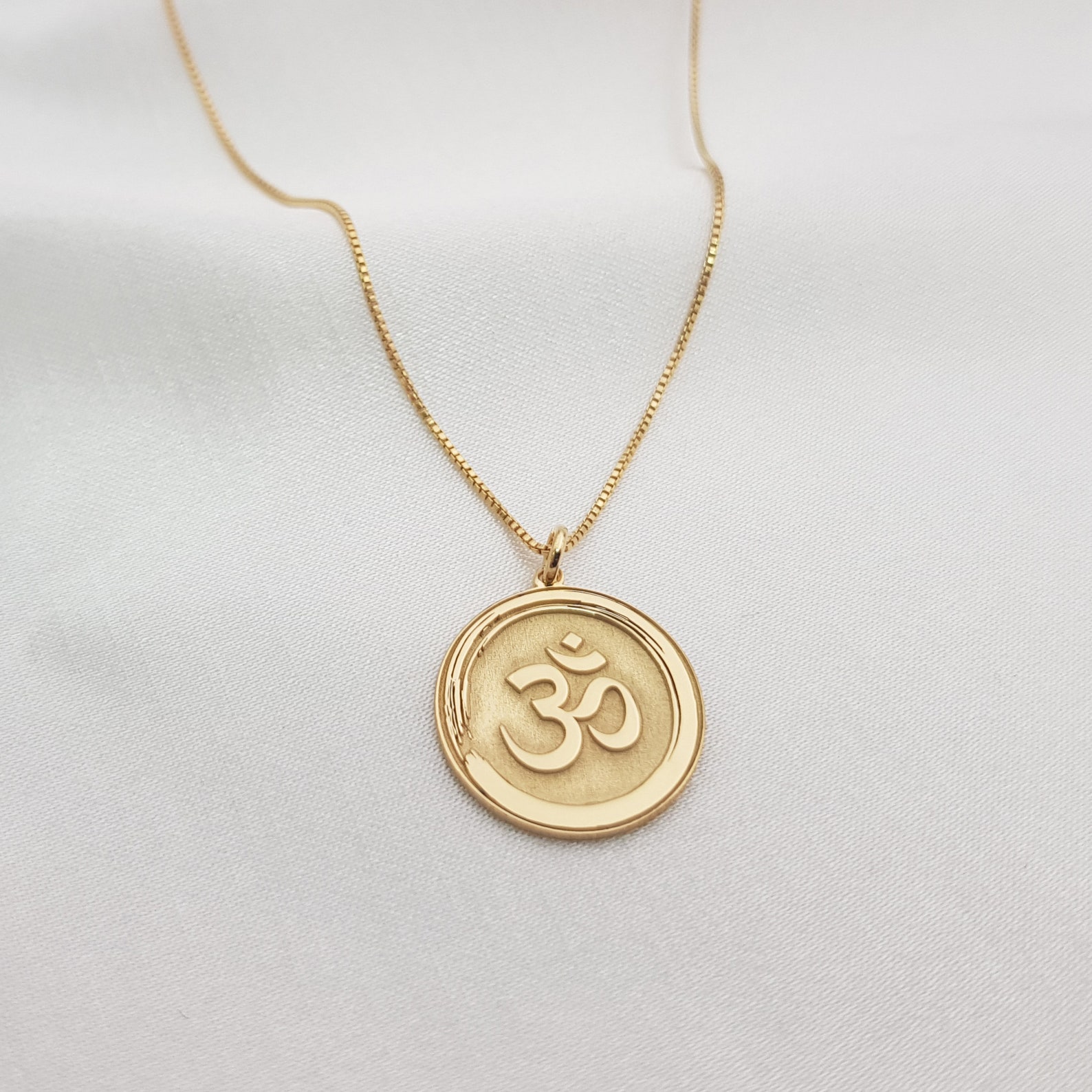 gold plated Om symbol pendant