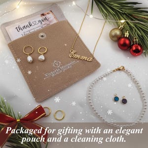 a necklace, earrings, and card on a white sheet