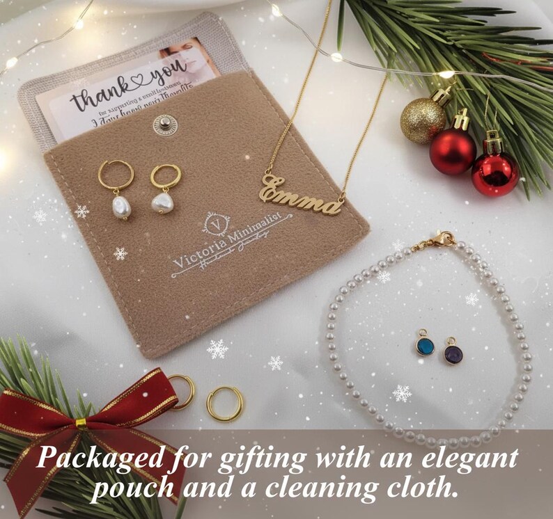 a necklace, earrings, and card on a white sheet