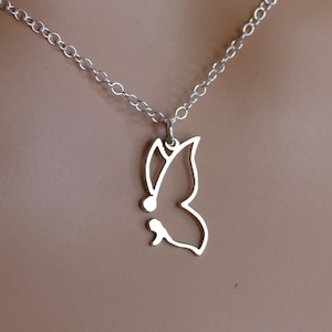 May include: A silver-colored butterfly pendant necklace. The butterfly design is a delicate outline, suspended from a fine chain. The necklace is a simple, elegant piece of jewelry.