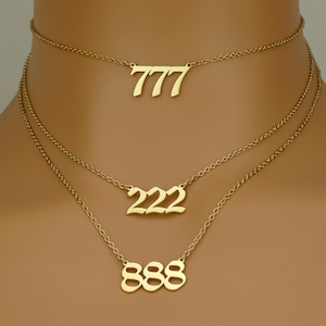 May include: Three gold necklaces with the numbers 777, 222, and 888 hanging from them.