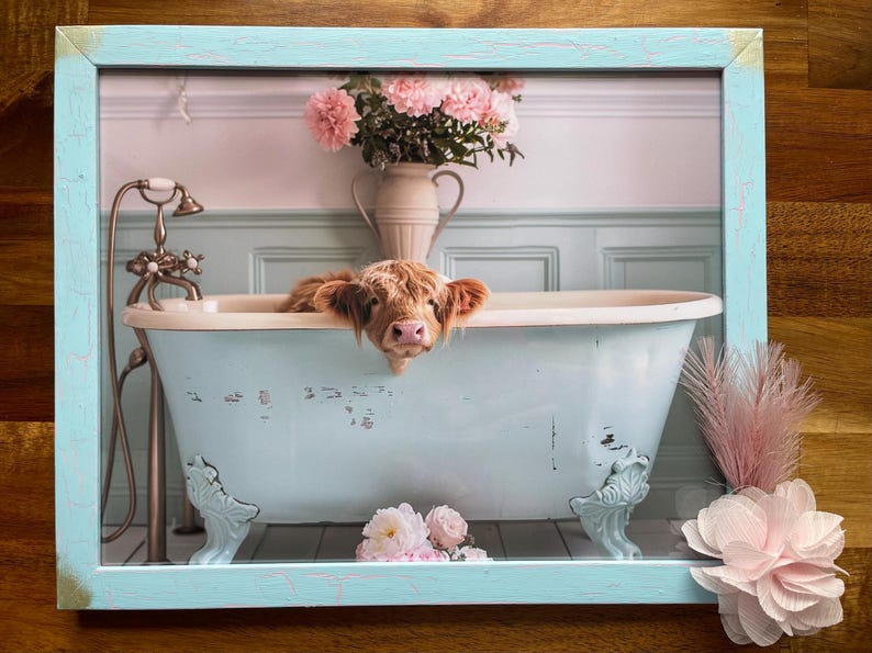 May include: A Highland cow taking a bath in a vintage clawfoot tub with pink flowers in the background.