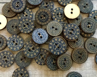 May include: A collection of wooden buttons with a blue and gold patterned design. The buttons are round and have two holes.