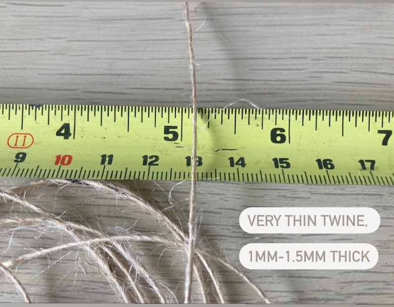 May include: A close-up of a thin, natural twine string measured against a yellow tape measure. The twine is approximately 1 to 1.5 millimeters thick. The text "VERY THIN TWINE, 1MM-1.5MM THICK" is visible below the twine.