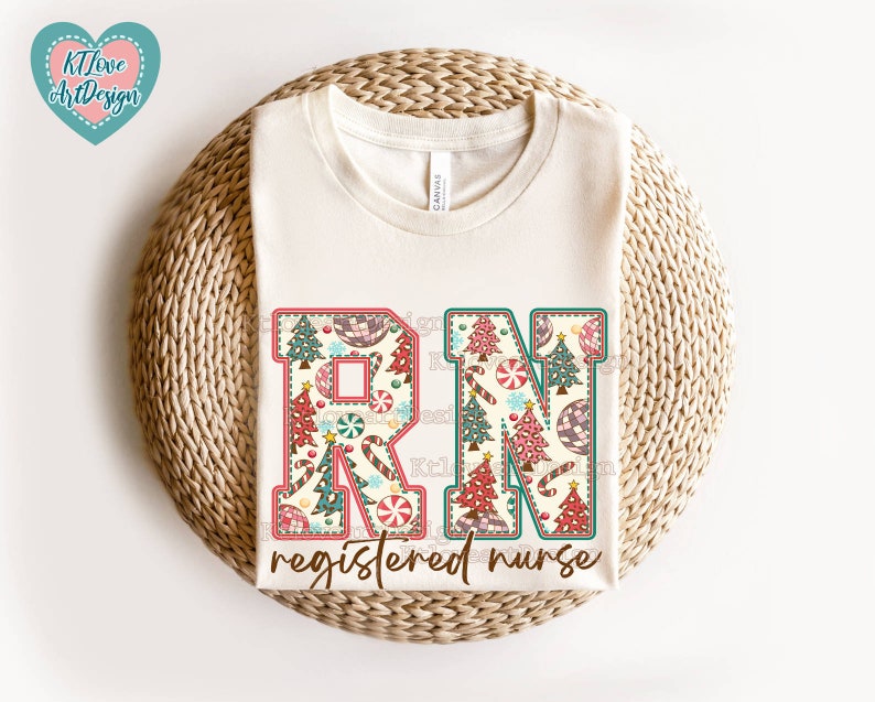 May include: A white t-shirt with a Christmas-themed design featuring the letters "RN" with a candy cane and Christmas tree pattern. The text "registered nurse" is below the letters.
