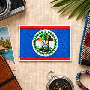 May include: A rectangular embroidered patch featuring the national flag of Belize. The design consists of a blue field with horizontal red stripes at the top and bottom, and a central white circle containing the coat of arms of Belize.