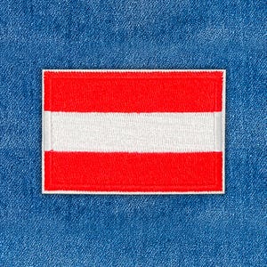May include: Rectangular patch featuring the flag of Austria, with a white stripe between two red stripes. The patch is bordered with white stitching and set against a blue denim background. Ideal for jackets, bags, or other fabric items.