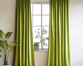 May include: A pair of green curtains hanging in a window. The curtains are made of a soft, textured fabric and have a subtle sheen.