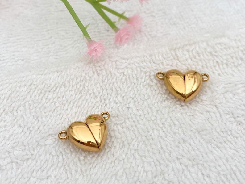 May include: Two gold-toned heart-shaped magnetic clasps for jewelry making.