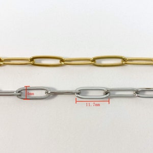 K&ouml;nnte beinhalten: Zwei Ketten mit ovalen Gliedern, eine goldfarben und eine silberfarben. Die silberne Kette ist 4 mm breit und 11,7 mm lang.