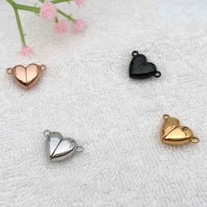 May include: Four heart-shaped magnetic clasps in different finishes: gold, silver, rose gold, and black. These clasps are perfect for jewelry making and crafting.