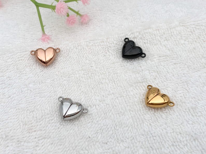 May include: Four heart-shaped magnetic clasps in different finishes: gold, silver, rose gold, and black. These clasps are perfect for jewelry making and crafting.