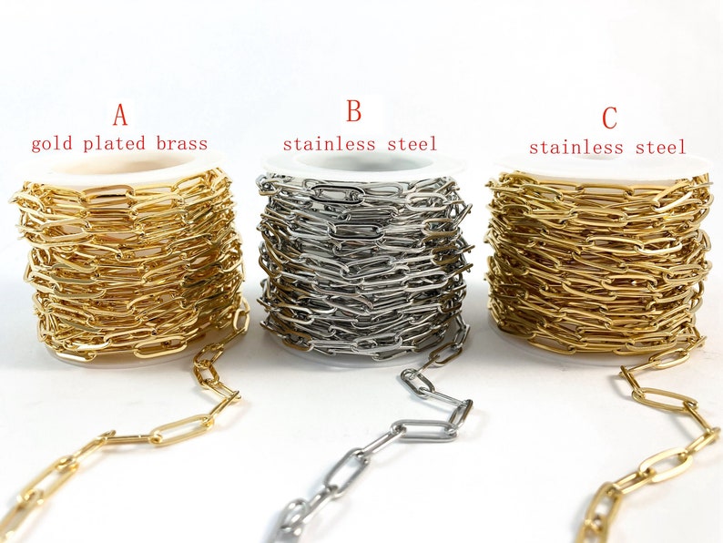 K&ouml;nnte beinhalten: Drei Spulen Kette, eine vergoldet Messing, eine silberfarben Edelstahl und eine goldfarben Edelstahl. Jede Spule ist mit dem Buchstaben A, B oder C und dem Materialtyp gekennzeichnet.
