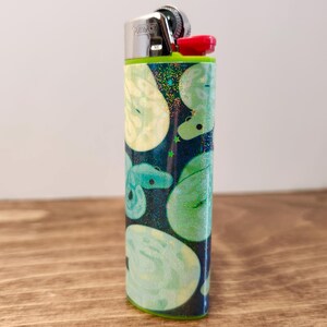 May include: A set of three ceramic mugs with a speckled, matte finish. The mugs are in shades of cream, light gray, and dark gray. Each mug has a simple, modern design and a comfortable handle.