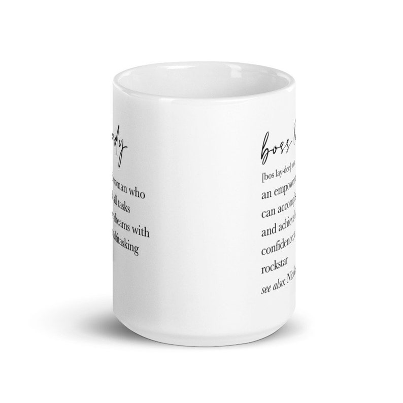 May include: White ceramic mug with the words "lady" and "boss lady" printed in black script. The mug features definitions of both terms. A stylish and motivational coffee mug.